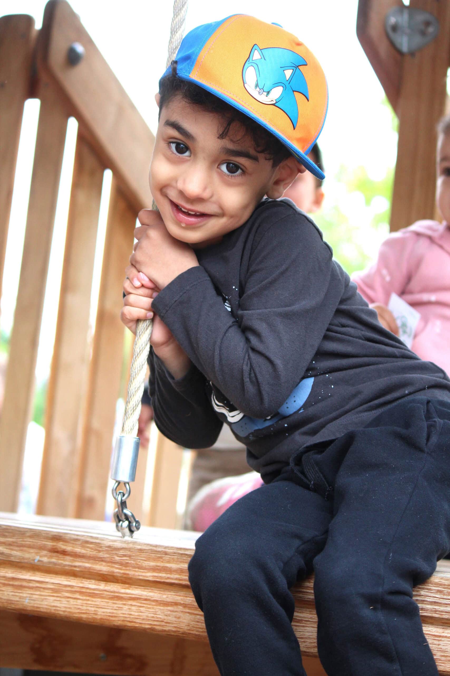A kid plays on the water tower at Village Square Park